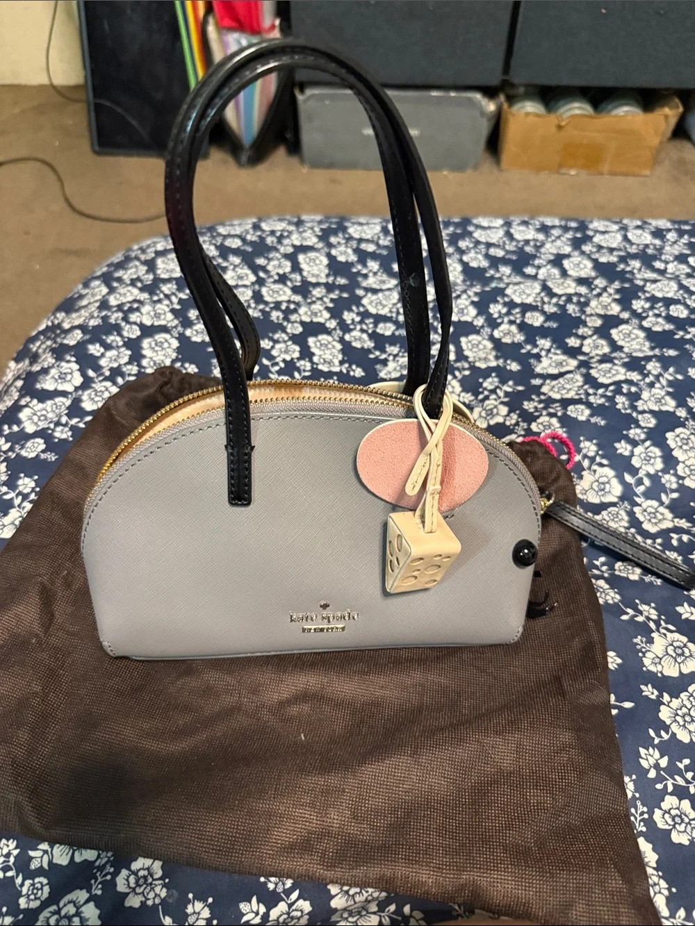 kate spade light gray dome satchel with black handles and charm